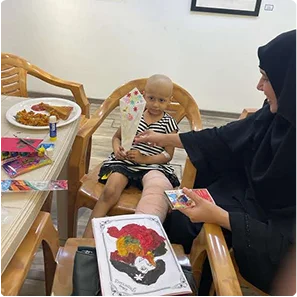 Child painting with a therapist
